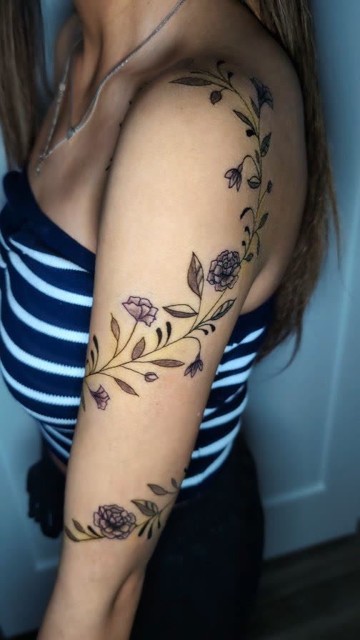Floral tattoo wrapping an upper arm.