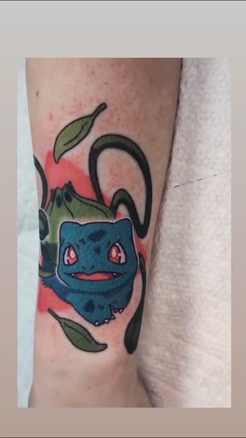Color tattoo of Bulbasaur on a forearm.
