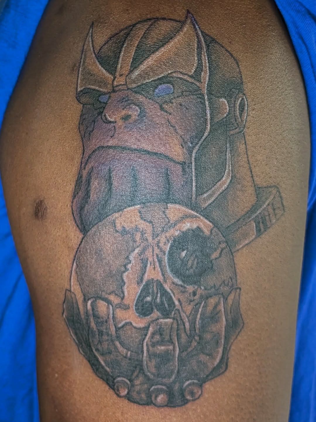 Color tattoo of Thanos on an upper arm.